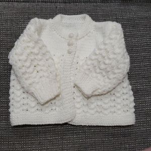 White knitted newborn sweater